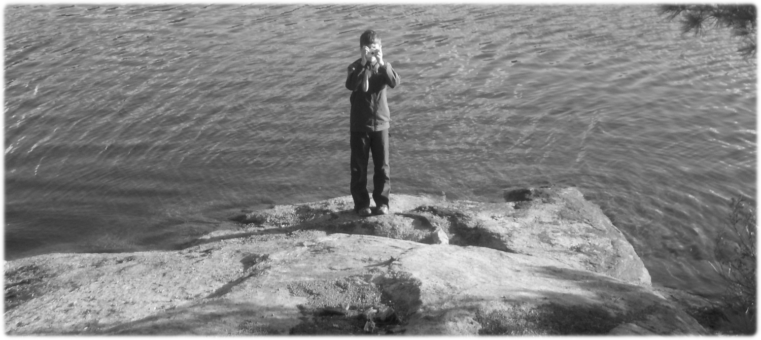 Black and white picture of William taking a picture